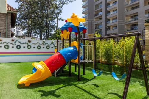 a playground with a slide in a park at Nandwa Ivy By YourHost, Kileleshwa, Nairobi in Nairobi