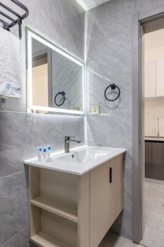 a bathroom with a sink and a mirror at Nandwa Ivy By YourHost, Kileleshwa, Nairobi in Nairobi