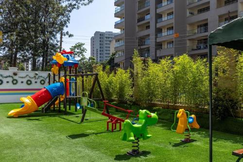 a playground with a play equipment in a yard at Nandwa Ivy By YourHost, Kileleshwa, Nairobi in Nairobi