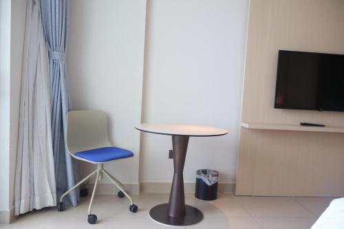 a table and a chair and a tv in a room at Luxury Beach Resort - Arena Cam Ranh in Cam Ranh International Airport