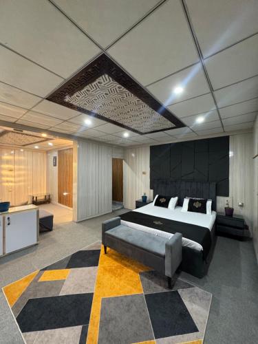 a large bedroom with a large bed and a checkerboard floor at Northlanders Guest House Skardu in Skardu
