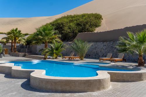 a swimming pool in the middle of the desert at Senoma Hotel - Adults only in Ica