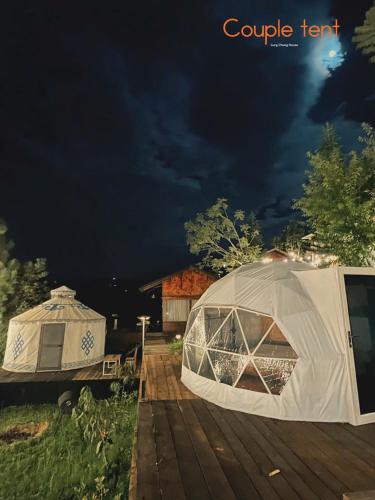 a tent and a yurt on a wooden deck at Lưng Chừng House in Da Lat