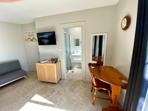 a living room with a table and a couch at Hills View BnB Studio Kiama Heights in Kiama