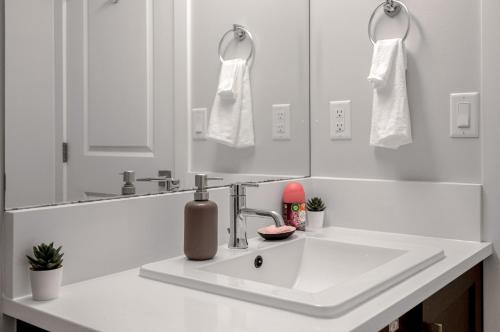 a white bathroom with a sink and a mirror at New 2BD Suite Near Events Center in Langley