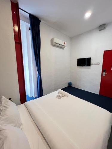 a bedroom with a white bed and a window at The Harbour by Moonknight in George Town