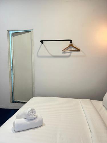 a white room with a bed and a mirror at The Harbour by Moonknight in George Town