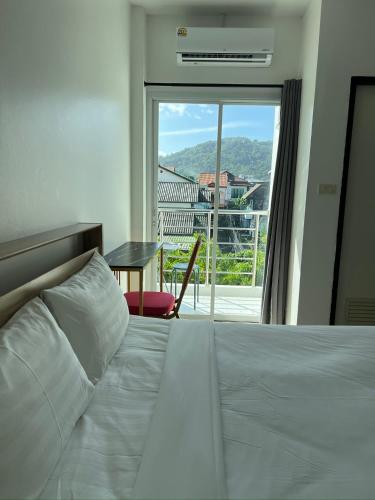 a bedroom with a bed with a view of a balcony at 07 Antalya Boutique Hotel in Patong Beach