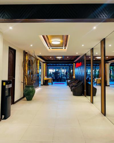 a lobby with couches and chairs in a building at Red Coconut Beach Hotel Boracay in Boracay