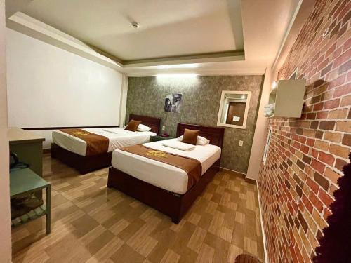 Cama o camas de una habitación en Cozi Hotel