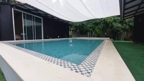a swimming pool with a tiled floor at เวลคัมโฮมขอนแก่น Welcome Home Khonkaen in Sathani Samran