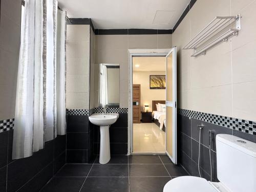 a bathroom with a sink and a toilet at Homigo - PWTC in Kuala Lumpur