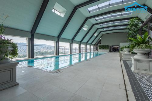 a large building with a swimming pool with windows at Paxtonz Empire City Damansara Petaling Jaya by Dream Inn in Petaling Jaya