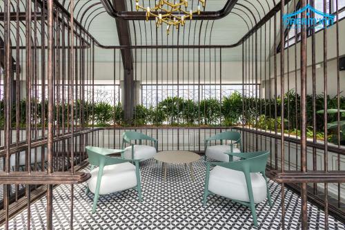 a room with chairs and a table and a chandelier at Paxtonz Empire City Damansara Petaling Jaya by Dream Inn in Petaling Jaya