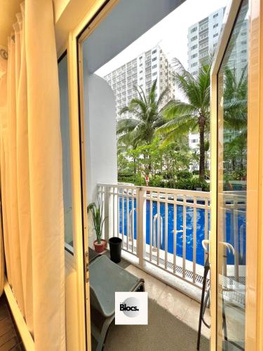 a balcony with a view of a pool at Direct to pool unit Shore Residences Condominium MOA Complex in Manila