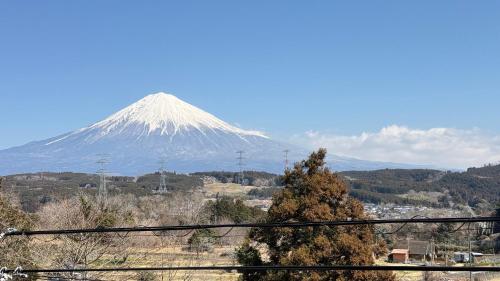 a snow covered mountain in the distance at Torinami Fuji View House in Fujinomiya