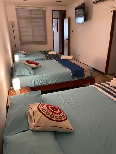 Ένα ή περισσότερα κρεβάτια σε δωμάτιο στο Iquitos Confort