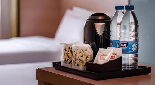 a tray with a coffee maker and drinks on a table at IU Hotel Kunming Jinma Bijifang Joy City in Kunming