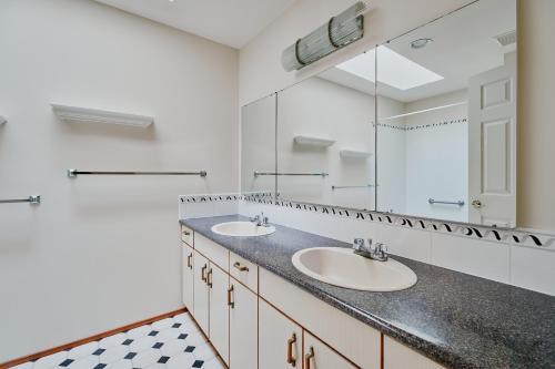 łazienka z dwiema umywalkami i dużym lustrem w obiekcie Tsawwassen 3 Bedroom Ground Suite w mieście Delta