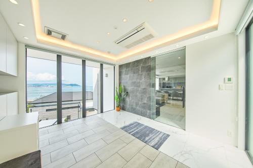 an empty living room with a view of the ocean at アナザーオーシャン淡路ヴィラ in Awaji