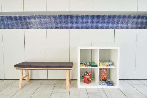 a bench in a room with a shelf with toys at アナザーオーシャン淡路ヴィラ in Awaji