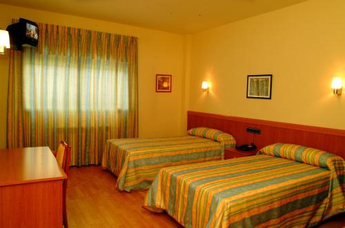 Voodi või voodid majutusasutuse Hotel Área Suco toas