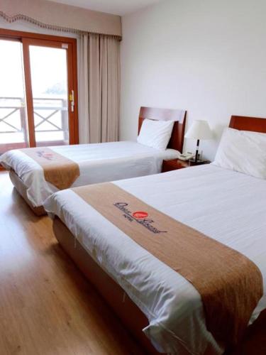 Ένα ή περισσότερα κρεβάτια σε δωμάτιο στο Ocean Grand Hotel