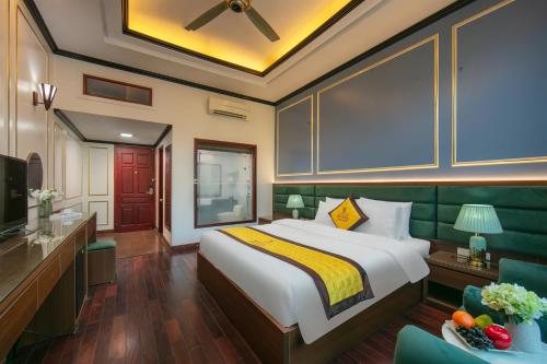 a hotel room with a bed and a television at Royal Hotel & Spa Bắc Ninh in Ðồng Ky