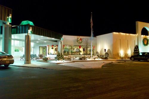 a large building with a flag in front of it at night at Fireside Inn & Suites Portland in Portland