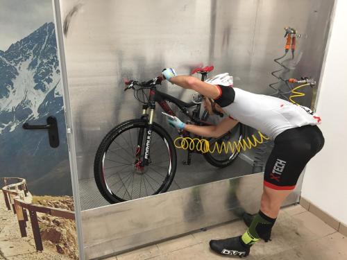 a person is putting a bike in a mirror at Hotel Garni Pegrà in Ponte di Legno