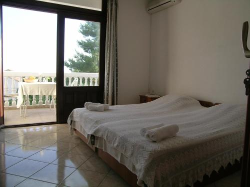 a bedroom with a bed with two towels on it at Apartments Marijan in Pakoštane