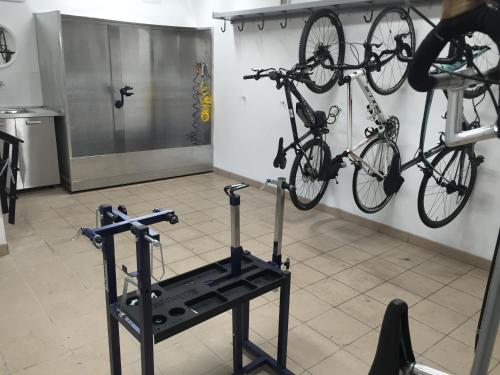 a room with two bikes hanging on a wall at Hotel Garni Pegrà in Ponte di Legno