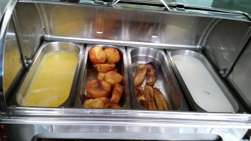 a container of food with a bunch of food at Coqueiros Express Hotel in Maceió
