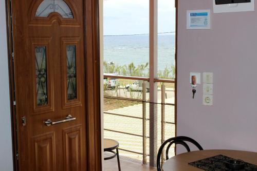 a door to a room with a view of the ocean at Seaview in Agios Georgios
