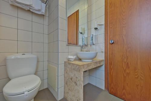 a bathroom with a toilet and a sink at Marin Hotel in Heraklio Town