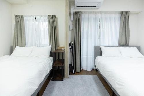 Una cama o camas en una habitación de リベール博多駅前505