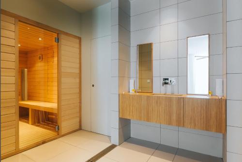 a bathroom with a sink and a mirror at Vila Baleira Village in Porto Santo