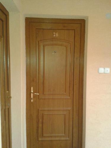 a wooden door with the number on it at Park Sétány Apartman in Balatonlelle