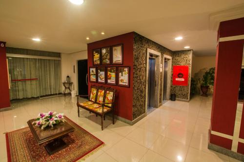 a lobby with a chair and a table in a room at SJ Tour - San Juan Foz do Iguaçu in Foz do Iguaçu