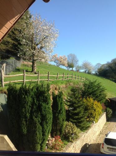 a garden with trees and a fence in a field at Le Sérènity in Le Landin