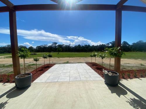 a patio with two potted trees in pots at Cottonvale Country Lodge 