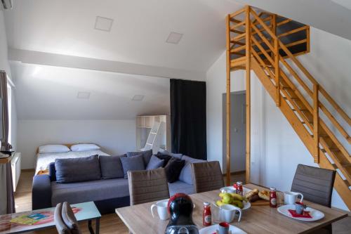 a living room with a blue couch and a table at Apartments Ema in Podčetrtek