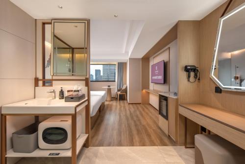 Ένα ή περισσότερα κρεβάτια σε δωμάτιο στο ELong Hotel Hangzhou West Lake