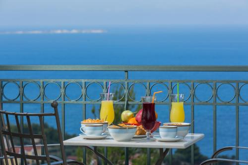 a table with food and drinks on a balcony at Ionian Vista Villas in Argostoli