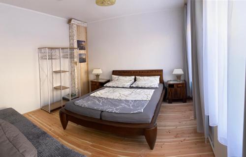 a bedroom with a bed and two night stands at Wohnung - Fisch Am kleinen Königsstuhl in Sagard