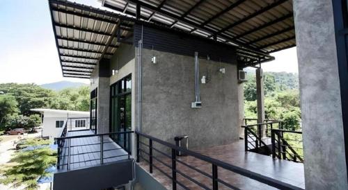a balcony of a house with a view at Ma-Kham Forest Resort in Nakhon Nayok