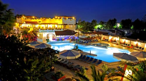 an aerial view of a pool at night at Gaia Garden in Kos Town