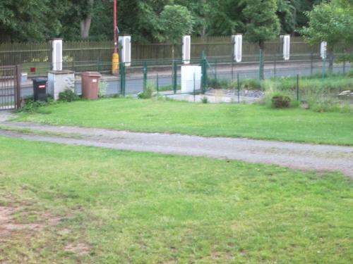 a walking path in a park with a fence at Apartmán U Borovice in Rychnov nad Kněžnou