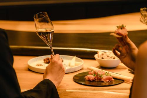 two people sitting at a table with a glass of wine at The Westin Yokohama in Yokohama