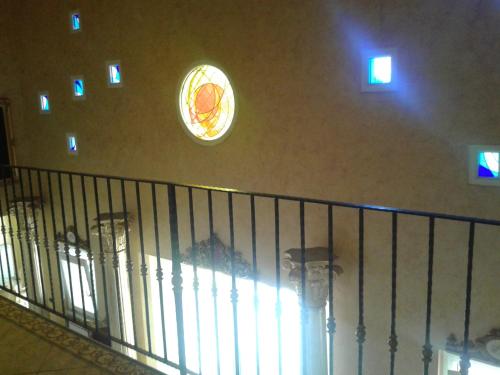 a clock on the wall of a building with a staircase at One M in Borgarello